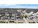Aerial view of a neighborhood showcasing modern homes, well-manicured lawns, and mountain views in the distance at 2054 S Upham Way, Denver, CO 80227