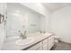 Bright bathroom with double sink vanity, large mirror, and sleek fixtures. Modern and clean design at 2054 S Upham Way, Denver, CO 80227