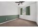 Vacant bedroom featuring plush carpeting, ceiling fan, and a large window offering natural light at 2054 S Upham Way, Denver, CO 80227