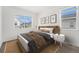 Bright bedroom with a large window, comfortable bed, and modern decor with a neutral color palette at 2054 S Upham Way, Denver, CO 80227
