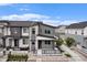 Modern two-story home showcasing gray siding, stone accents, and a cozy front porch in a residential area at 2054 S Upham Way, Denver, CO 80227