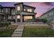 Contemporary two-story home featuring stone accents, a front porch, and well-maintained landscaping at 2054 S Upham Way, Denver, CO 80227