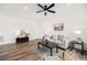 Cozy living room showcasing hardwood floors, neutral decor, and ample natural light, with modern furnishings at 2054 S Upham Way, Denver, CO 80227