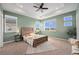 Spacious main bedroom featuring a tray ceiling, carpeted floors, and large windows offering a bright airy feel at 2054 S Upham Way, Denver, CO 80227