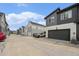 Charming street view showcasing modern townhomes with garages, enhanced by landscaped front yards at 2054 S Upham Way, Denver, CO 80227
