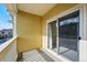 Cozy outdoor balcony with yellow siding and view of the parking area and a neighbor's unit at 9434 Ashbury Cir # 203, Parker, CO 80134