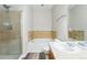 Bathroom featuring a shower, bathtub, and single sink vanity with neutral tile at 9434 Ashbury Cir # 203, Parker, CO 80134