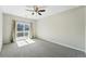 Bright bedroom with a ceiling fan and sliding glass door leading to a balcony at 9434 Ashbury Cir # 203, Parker, CO 80134