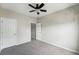 Spacious carpeted bedroom with soft, gray walls, white doors and trim, and a ceiling fan at 9434 Ashbury Cir # 203, Parker, CO 80134
