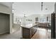 Open concept kitchen with gray cabinets, a large island, and seamless flow to living area at 9434 Ashbury Cir # 203, Parker, CO 80134