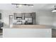 Bright kitchen featuring stainless steel appliances, gray cabinets, and spacious countertops at 9434 Ashbury Cir # 203, Parker, CO 80134