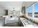 Kitchen with stainless steel sink, gray cabinets, and an open view to the living area with fireplace at 9434 Ashbury Cir # 203, Parker, CO 80134