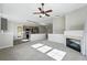 Open-concept living area with fireplace seamlessly connected to modern kitchen and a breakfast bar at 9434 Ashbury Cir # 203, Parker, CO 80134