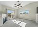 Bright and airy main bedroom with a fireplace, balcony access, and large windows at 9434 Ashbury Cir # 203, Parker, CO 80134