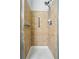 Walk-in shower features neutral tiling, and shower head at 9434 Ashbury Cir # 203, Parker, CO 80134