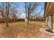 Wide backyard with a well-maintained lawn, privacy fence, and convenient access to the home at 1515 Sagrimore Cir, Lafayette, CO 80026