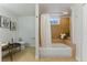 Well-lit bathroom featuring a bathtub with tiled surround and modern fixtures at 1515 Sagrimore Cir, Lafayette, CO 80026
