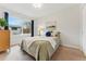 Cozy bedroom with neutral decor, a plush bed, and a large window for natural light at 1515 Sagrimore Cir, Lafayette, CO 80026