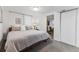 Light-filled bedroom with neutral colors and a glimpse into the living space at 1515 Sagrimore Cir, Lafayette, CO 80026