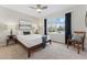 Comfortable bedroom with soft carpet, a ceiling fan, and a large window with pleasant view at 1515 Sagrimore Cir, Lafayette, CO 80026