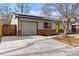 Single story home with brick accents, solar panels, and a large driveway at 1515 Sagrimore Cir, Lafayette, CO 80026