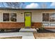 Close up of the front door showing brick accents, fresh mulch and a green door at 1515 Sagrimore Cir, Lafayette, CO 80026