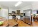 Modern kitchen with stainless steel appliances, white cabinetry, and an adjacent dining area at 1515 Sagrimore Cir, Lafayette, CO 80026