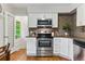 Well-appointed kitchen with white cabinets, stainless steel appliances, and a stylish backsplash at 1515 Sagrimore Cir, Lafayette, CO 80026