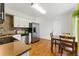 Charming kitchen with bright white cabinets, stainless appliances, and a cozy breakfast nook at 1515 Sagrimore Cir, Lafayette, CO 80026