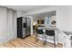 Kitchenette with stainless steel refrigerator and bar seating in open concept area at 1515 Sagrimore Cir, Lafayette, CO 80026