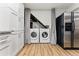 Convenient laundry area with modern appliances and ample storage space, adjacent to stainless steel refrigerator at 1515 Sagrimore Cir, Lafayette, CO 80026