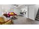 Bright living room with a bar, red couch, and stairs in an open space at 1515 Sagrimore Cir, Lafayette, CO 80026