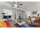 Cozy living room with ceiling fan and a view of the kitchen and bedroom at 1515 Sagrimore Cir, Lafayette, CO 80026