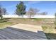 Large backyard with a wooden deck, retaining wall, and plenty of space for entertaining at 441 Grey Swallow St, Brighton, CO 80601