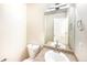 Well-lit bathroom featuring a single sink vanity, toilet, and towel rack at 441 Grey Swallow St, Brighton, CO 80601