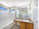 Clean bathroom featuring a shower-tub, large mirror, and wood-style vanity at 441 Grey Swallow St, Brighton, CO 80601