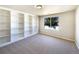 Cozy bedroom featuring built-in bookshelves and a large window at 441 Grey Swallow St, Brighton, CO 80601
