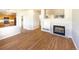 Spacious living room with fireplace and hardwood floors leading to the kitchen at 441 Grey Swallow St, Brighton, CO 80601