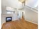 Open-concept living room featuring a fireplace, staircase, and hardwood floors at 441 Grey Swallow St, Brighton, CO 80601