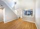 Sun-filled living room with staircase, large windows, and hardwood flooring at 441 Grey Swallow St, Brighton, CO 80601
