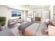Bright main bedroom featuring a large window, ensuite bathroom, and neutral decor at 441 Grey Swallow St, Brighton, CO 80601