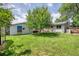 Large, grassy backyard with mature trees and a detached garage at 1346 S Grant St, Longmont, CO 80501