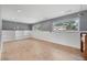 Finished basement featuring built-in shelving, ample natural light from multiple windows, and neutral decor at 1346 S Grant St, Longmont, CO 80501