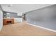 Spacious finished basement area with desk, stairs, and neutral tile flooring at 1346 S Grant St, Longmont, CO 80501