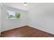 Minimalist bedroom with hardwood floors and large window providing natural light at 1346 S Grant St, Longmont, CO 80501