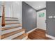 Cozy entryway featuring hardwood floors, neutral paint, stairway, and access to the main living area at 1346 S Grant St, Longmont, CO 80501