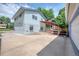 Side view of the property featuring an outdoor pergola and large driveway at 1346 S Grant St, Longmont, CO 80501