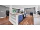 Open kitchen design with custom blue island, cooktop, and white countertop, adjacent to living area at 1346 S Grant St, Longmont, CO 80501