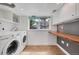 Bright laundry room with modern washer and dryer, a folding counter, and ample storage space at 1346 S Grant St, Longmont, CO 80501