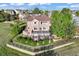 Aerial view of a backyard with a spacious deck, patio, and lush landscaping at 4704 Cedar Glen Pl, Castle Rock, CO 80109